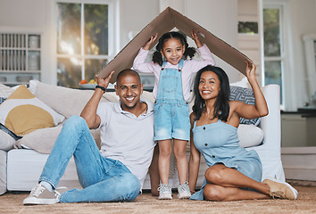 Image showing Portrait, cardboard roof and family in the lounge, home insurance and care with protection, smile and safety. Face, parents or mother with father, girl and daughter in the living room, love and cover