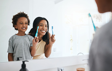 Image showing Teaching, mama and son brushing teeth, wellness and cleaning mouth at home, bathroom and smile. Family, female parent and mother with male child, kid and boy with reflection, health or dental hygiene