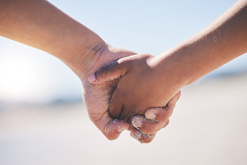 Image showing Love, unity and couple holding hands at a beach with trust, solidarity and commitment in nature. Hand, care and man with woman on romantic walk at the sea, sweet and bonding while traveling together