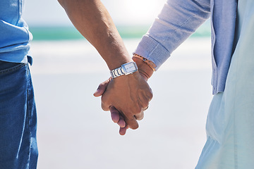 Image showing Unity, love and couple holding hands at a beach with trust, solidarity and commitment in nature. Hand, care and man with woman on romantic walk at the sea, sweet and bonding while traveling together