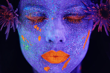 Image showing Creative, face and woman with neon paint in studio for art freedom, fantasy or colorful aesthetic. Creativity, artistic and closeup of female model with facial psychedelic makeup by black background.