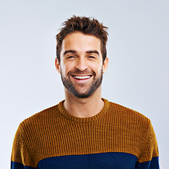 Image showing Portrait, smile and man with positive, confidence and carefree against a grey studio background. Face, male person and human with a cheerful attitude, freedom and model with joy, Canada and relax