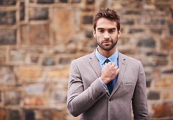 Image showing Business man, portrait and city wall with fashion, confidence and success in entrepreneurship. Young businessman, executive and suit in urban street, road or side walk with focus, style and outdoor