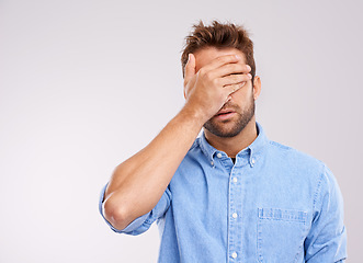 Image showing Mockup, covering eyes and man with regret, mistake and guy against a grey studio background. Male person, model or human with hand on face, frustrated and problem with an issue, upset or disappointed