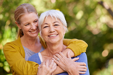 Image showing Senior mother, woman and hug outdoor with happiness, love and care in portrait by trees on holiday. Elderly mama, lady and embrace with bond, excited face and support in backyard with summer sunshine