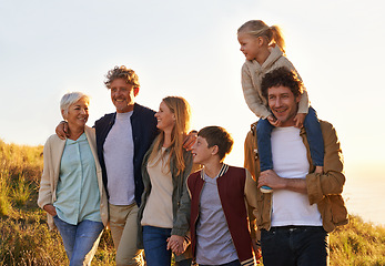 Image showing Love, countryside and family bonding, smile and quality time with happiness, walking and relax. Grandparents, mother and happy father carry daughter, siblings and loving outdoor, break and adventure