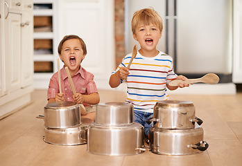 Image showing Children, playing and pots for music or noise in family home or kitchen for happiness, fun and portrait. Male kids or friends together for a portrait, play and drum instrument for freedom and fantasy