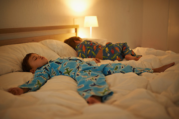 Image showing Two brothers, sleeping and night in bed for rest together, peace and health in family home. Young tired kids, boy children and tired with calm sleep, fatigue and dream on blanket in bedroom at house