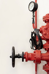 Image showing Fire station, hydrant or pump for emergency with faucet, valve or gauge to control water pressure. Metal firefighter equipment, health and safety tools for public services by wall background for help