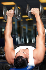 Image showing Fitness, dumbbell bench press and man doing workout performance, gym exercise routine or strength training for bodybuilding. Wellness, healthy and ripped bodybuilder person working on weightlifting