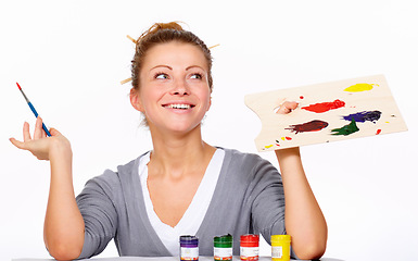 Image showing Art, painting and thinking with happy woman in studio with creativity, talent and paint brush for color. Female artist or painter isolated on a white background for creative work and idea for palette