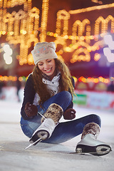 Image showing Smile, ice skating and woman tie shoes on rink to start fitness, exercise and workout at night. Skater, happiness and female person tying skates for winter training, preparing and getting ready.