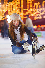 Image showing Ice skating, happy and woman tie shoes on rink to start fitness, exercise and workout at night. Skater, smile and female person tying skate laces for winter training, preparing and getting ready.