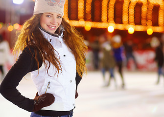 Image showing Woman, ice skating portrait and happiness in night for workout, training and exercise on winter holiday. Girl, skate rink and happy for sports, outdoor and fitness with excited face for vacation