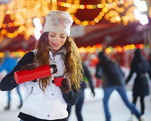 Image showing Outdoor, winter and woman with coffee, smile and cold with beverage, thermos and snow. Female person, girl and model with a flask, outside and happiness with tea, cocoa and fun with frosty weather
