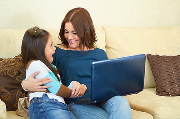 Image showing Love, hug and mother with her child on a laptop while relaxing, talking and bonding on sofa. Happy, smile and young mom embracing girl kid while browsing on social media with computer in living room.