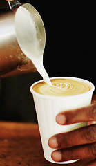 Image showing Milk, coffee and hands of barista in cafe for cappuccino, restaurant and shopping. Retail, morning and espresso with closeup of man and pouring in cup for drink, latte art and preparation in store