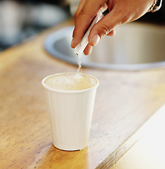 Image showing Sugar, coffee and hands of person in cafe for cappuccino, restaurant and shopping. Retail, morning and espresso with closeup of man and pouring in cup for drink, latte art and preparation in store