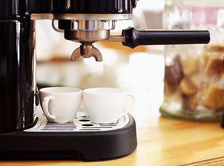 Image showing Coffee, cups and machine on table in cafe for cappuccino, latte or hot drink. Restaurant, electrical appliance and caffeine mug for making or brewing espresso in retail shop or small business.