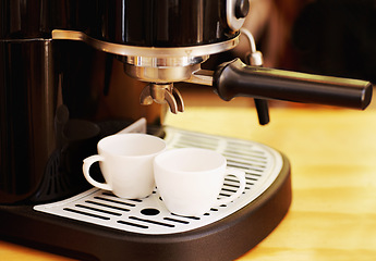 Image showing Coffee maker, cups and machine on table in cafe for cappuccino, latte or hot drink. Restaurant, electrical appliance and caffeine cup for making or brewing espresso in retail shop or small business.