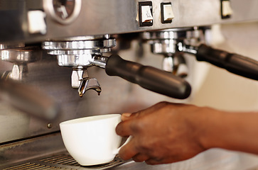 Image showing Hand, woman barista using coffee machine and expresso or latte being made. Closeup, female waiter working in restaurant or cafeteria and cup with brewing process making a hot drink or beverage