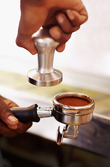 Image showing Coffee, ground and barista hands press espresso with tamper, portafilter and fresh caffeine at cafe, hotel or restaurant. Brewing, beverage or cappuccino machine equipment for professional drink