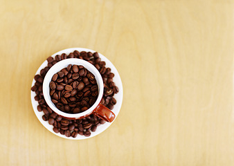 Image showing Coffee beans, roasted and cup for cafe industry with quality product and space for marketing or advertising. Above wooden table mockup background with grain as drink, espresso or caffeine ingredient