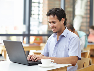 Image showing Student man, laptop and cafe with smile, typing and research on internet for studying. Young guy, computer and coffee shop with happiness, reading and social media for news, search or video on web