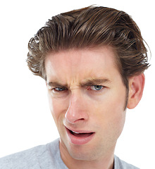 Image showing Confused, closeup and portrait of man in studio for frustrated, disgusted and doubt. Goofy, displeased and unhappy with face of male isolated on white background for wow, funny and crazy expression
