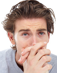 Image showing Man, depressed crying and hands in studio with mental health problem, lost and frustrated by white background. Male model, sad student and anxiety with tears, depression and thinking with stress