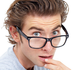 Image showing Surprised, portrait and man in glasses with shock, worry or anxiety closeup on white studio background. Omg, wow or wtf and nerd, geek reaction and fear, stress, shocked expression and isolated face