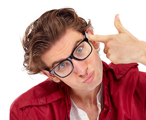 Image showing Finger gun, portrait and man in a studio with a comic silly, funny and goofy face expression. Crazy, quirky and male model with glasses posing with a shoot gesture isolated by a white background.