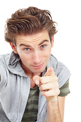 Image showing Face, portrait of man pointing and in a white background. Encouragement or selection, isolated male fashion model showing direction with smirk for confidence and hey you in a studio backdrop