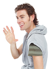 Image showing Happy, casual and man waving in a studio for greeting with a stylish and trendy outfit. Happiness, smile and male model with fashion or style doing a hello hand gesture isolated by a white background