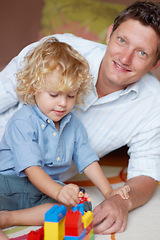 Image showing Father relax with boy child, building blocks with toys for development and growth, playing together while at home. Family, man bonding with kid and learning, educational play time in portrait