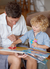 Image showing Man with boy child, reading book for education and development, spending quality time together at home. Family, teaching and learning with father and kid bonding, picture story with toys for growth