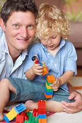 Image showing Father is happy with boy child, building blocks and toys for learning and development with educational play time. Education, growth and playing together, man smile in portrait with kid at home