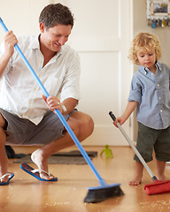 Image showing Man is cleaning with boy kid, sweeping with broom and help with mess on floor while at home together. Hygiene, chores and house work with man teaching child to sweep and helping with crumbs on ground