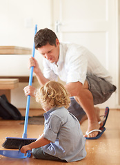 Image showing Man is sweeping with boy kid, cleaning with broom and help with mess on floor while at home together. Hygiene, chores and house work with man and child bonding and helping with crumbs on ground