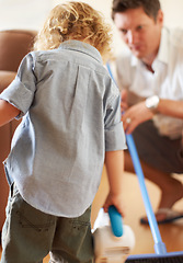 Image showing Boy, dad and vacuum cleaner on floor together with learning, support or cleaning in family home with care. Man, male child and teaching life skills with love, broom and development for clean flooring