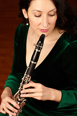 Image showing Music, performance and woman playing clarinet, orchestra musician, creative talent and classical show. Art, focus and female artist, professional concert clarinetist with creativity and inspiration.