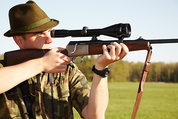 Image showing Hunting, gun scope and man hunter on Africa safari in grass for shooting animals on holiday. Weapon, sniper and male person aim for wild game in nature with mockup and sport for target shot in sun