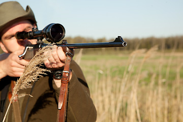 Image showing Hunting, gun and man on a Africa safari in the grass for shooting animals on holiday. Weapon, sniper and male person aim for wild game in nature with mockup and scope for target shot in the sun