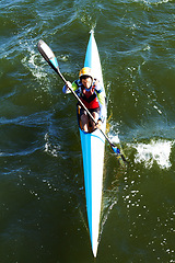 Image showing Relax, travel and kayak with man in river for vacation trip, summer and water sports from above. Nature, health and peace with male kayaker rowing in canoe boat for fitness, competition and race