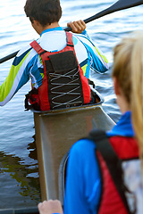 Image showing Back, man and woman on water in kayak for rowing, sport and fitness for health, wellness and teamwork. Rowing team, boat and adventure for sports, freedom and exercise on river, dam or lake in nature