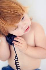 Image showing Phone call, playing and cute young kid at home with ginger hair and youth. Conversation, telephone and learning child with communication and listening in a house with confidence and childhood