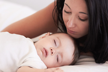 Image showing Baby, sleeping and mother in a home bedroom with parent support, care and love. Relax, bed and young girl with mom in a house feeling tired and sleepy with mama rest looking at fatigue of kid