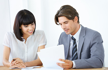 Image showing Business people with paperwork in meeting, team and planning in office conference room with collaboration. Employees smile while working together, man and woman with teamwork and corporate documents