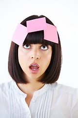 Image showing Confused, planning and woman brainstorming in studio with a shock, surprise or thinking face expression. Idea, contemplating and female model with paper notes on her head isolated by white background