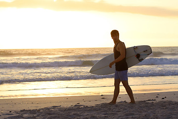 Image showing Sunset, surfing man and walking at the beach with surfboard. Athlete, summer vacation or holiday and professional male surfer training or exercising water sports at the ocean or sea on mockup space